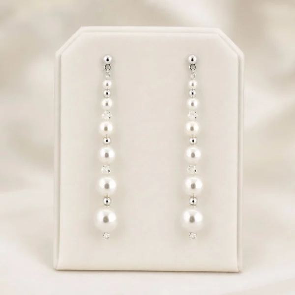 P904E Pearl & Crystal Drop Earrings - Richard Designs with graduated ivory pearls, crystal beads and silver bead detailing. on satin stand