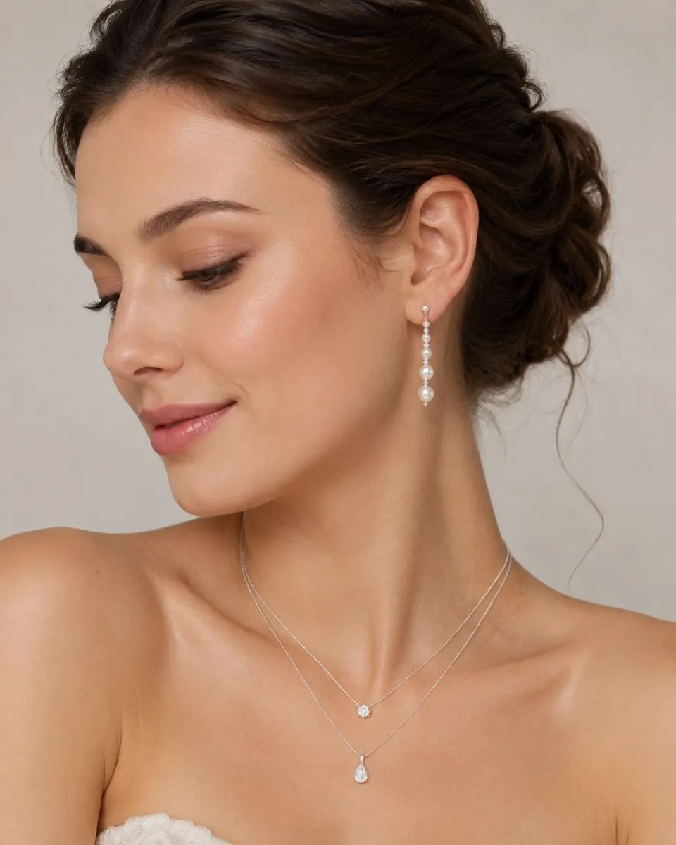 P904E Pearl & Crystal Drop Earrings - Richard Designs with graduated ivory pearls, crystal beads and silver bead detailing.