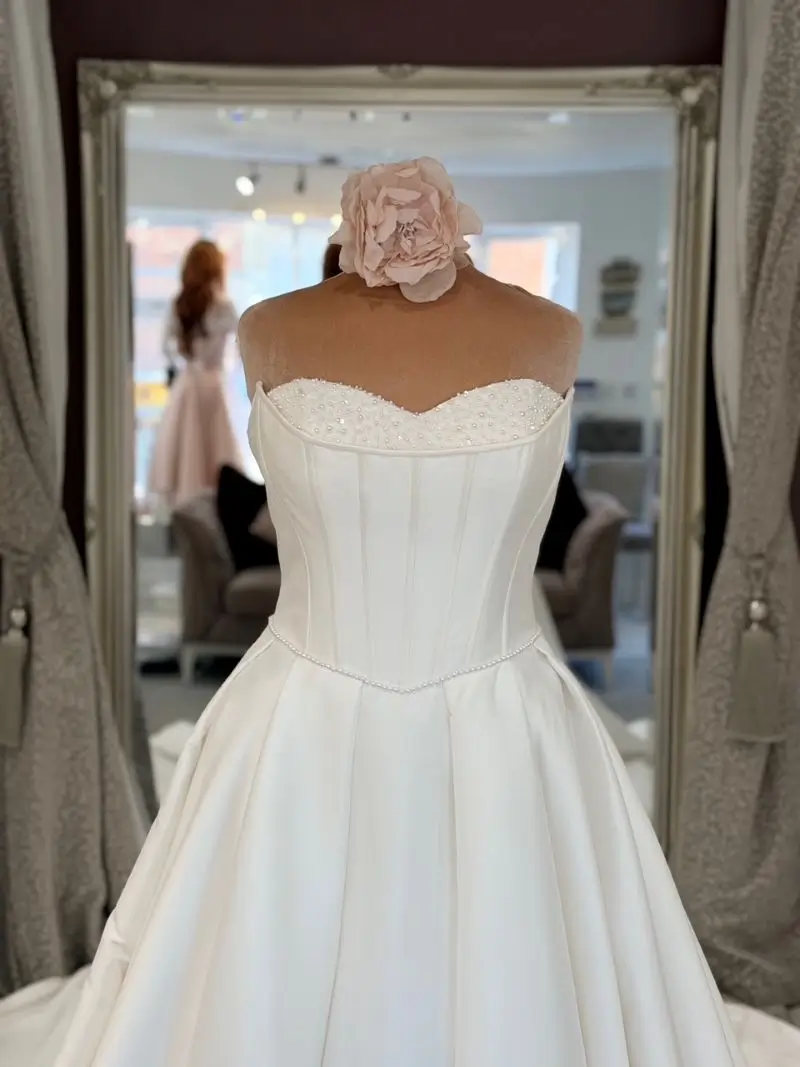 Bride trying on wedding dresses at The Bridal Affair & Curvy Bridal appointment