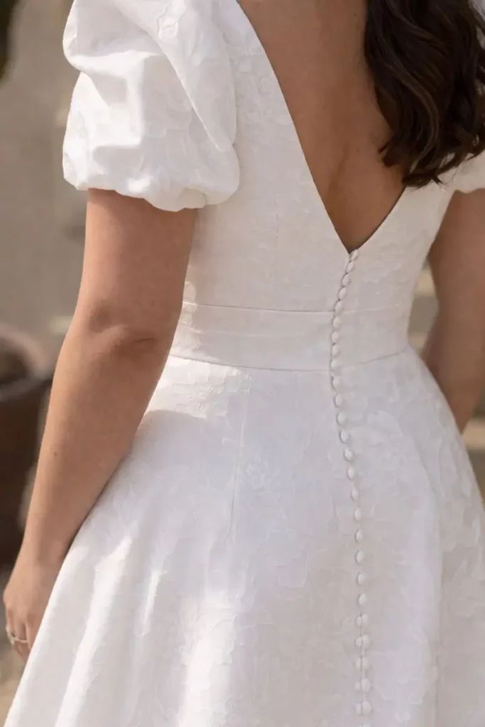 Close-up of the back detail and buttons on a wedding dress at The Bridal Affair & Curvy Bridal