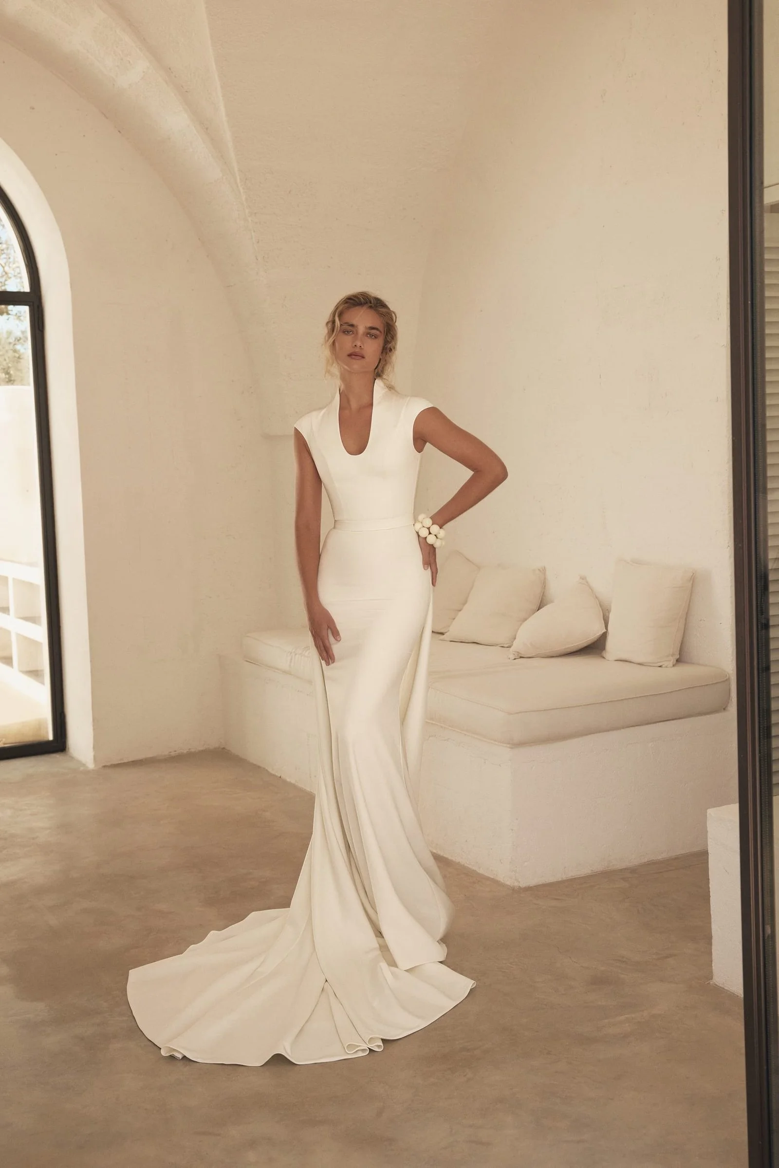 Eva Lendel Appolo ivory wedding dress back view with cap sleeves, fitted silhouette and flowing train