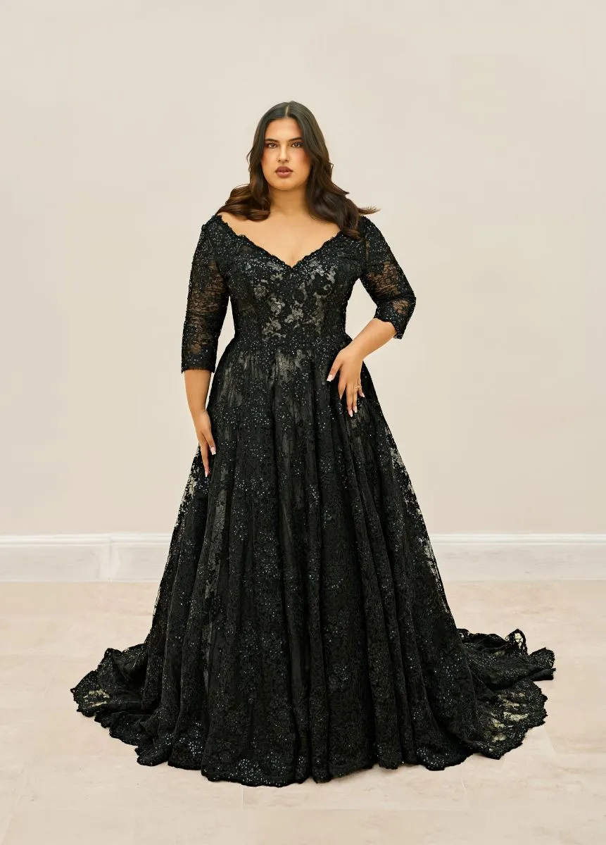 Enora by Envy by Phoenix Gowns black lace wedding dress with V-neckline, hand-beaded floral appliqu&eacute;s and three-quarter lace sleeves.